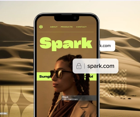 A screenshot of the Spark.com website shown on a mobile phone in front of a desert landscape.